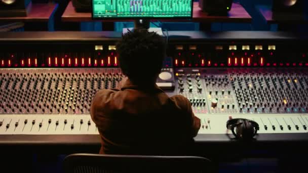Sound Designer Editing Tracks Adjusting Volume Levels Panel Board Knobs — Stock Video