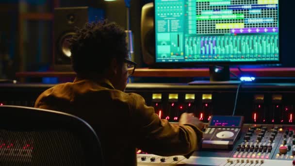 Sound Designer Uses Mixing Console Managing Audio Tracks Twisting Knobs — Stock Video