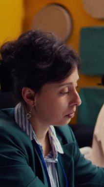 Başlangıç ekibi dizüstü bilgisayardaki mali raporları ve performans ölçümlerini yıllık veri raporları için satış istatistikleri ve bilgi grafiklerini kullanarak gözden geçirecek. Yönetici ve personel pazar taleplerini araştırıyor. Kamera B.