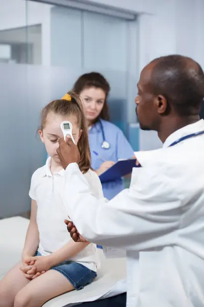 Afroamerikanische Ärztin Benutzt Thermometer Kleinem Mädchen Fieber Der Arztpraxis Kontrollieren — Stockfoto