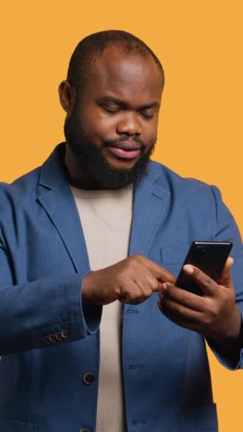 Vertical Video Portrait Energetic Happy Man Holding Smartphone Celebrating Throwing — Stock Video