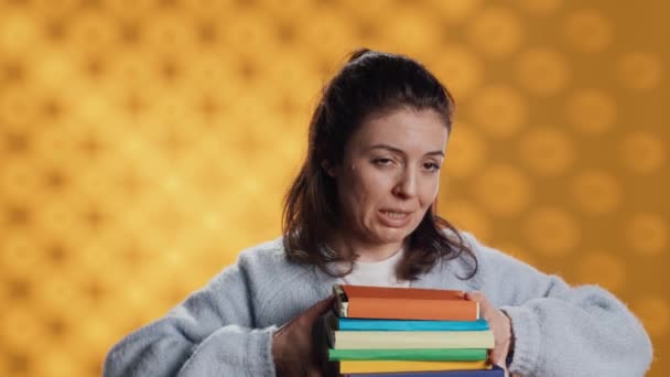 Woman Choosing Physical Books Ebooks Favoring Ereader Lightness Studio Background — Vídeo de stock
