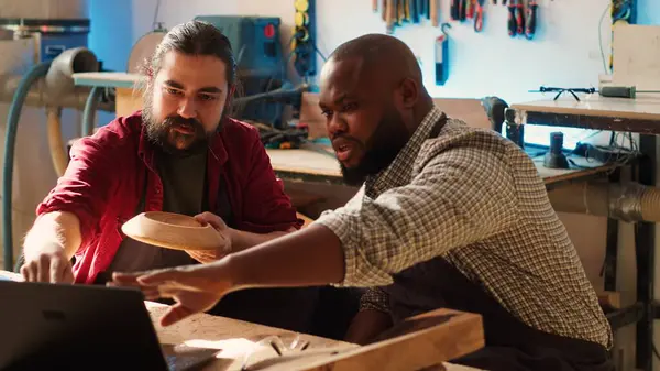 Houtbewerker Bekijkt Blauwdrukken Laptop Brainstormend Met Afro Amerikaanse Leerling Team Rechtenvrije Stockfoto's
