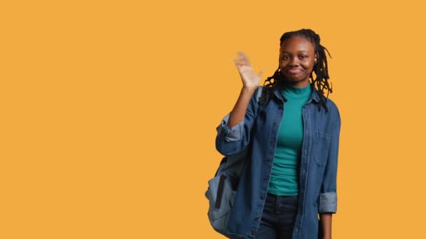 Portrait Happy Woman Waving Hand Saluting Gesturing Isolated Yellow Studio — Stock Video