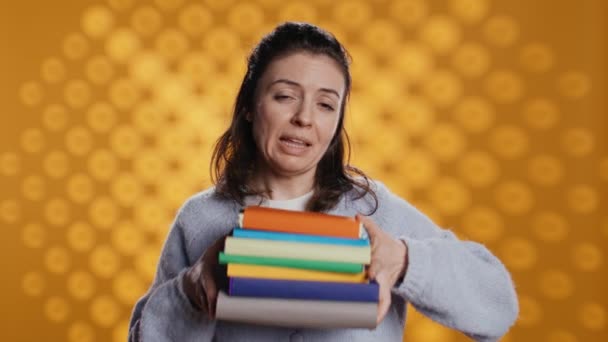 Woman Choosing Physical Books Ebooks Favoring Ereader Lightness Studio Background — Video