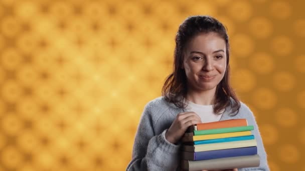 Portrait Smiling Woman Pointing Empty Copy Spaces While Holding Pile — Video