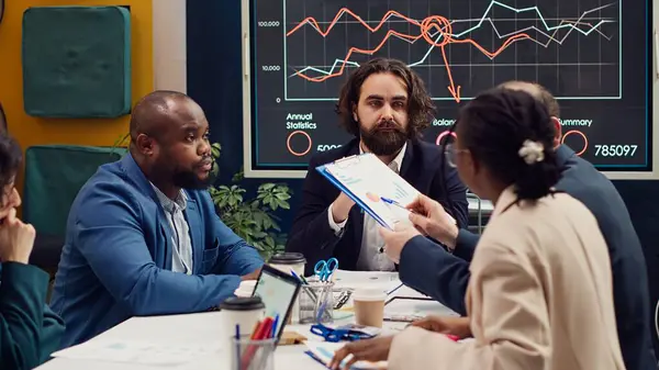 stock image Business team trying to eliminate risks of unforeseen events and disruptions, discussing supply chain resilience and contingency planning. Diverse staff members accomplishing goals. Camera A.