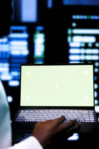 Stock image Close up shot of specialist examining server cabinets performance trends using chroma key device. Employee using mock up laptop to spot data center operational issues causing servers to malfunction