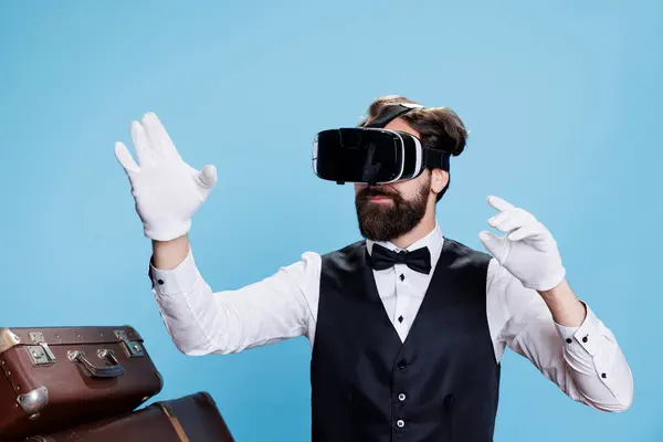 Classy Bellboy Using Virtual Reality Headset Symbolizing Modern Hospitality Industry Royalty Free Stock Images
