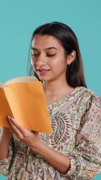 Vertical Video Cheerful Woman Smiling While Enjoying Reading Activity Holding — стокове відео