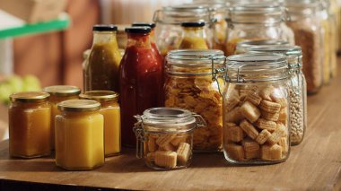 Close up on bulk food items in reusable glass jars used by environmentally friendly supermarket to lower climate impact. Local shop pantry staples in biodegradable nonpolluting packaging, panning shot clipart