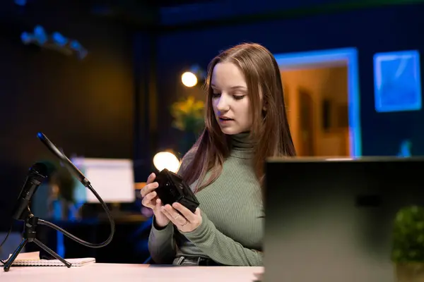 stock image Gen Z content creator reviews large capacity V mount battery used to power high end devices on niche online channel. Girl showcasing rechargeable portable lithium power source
