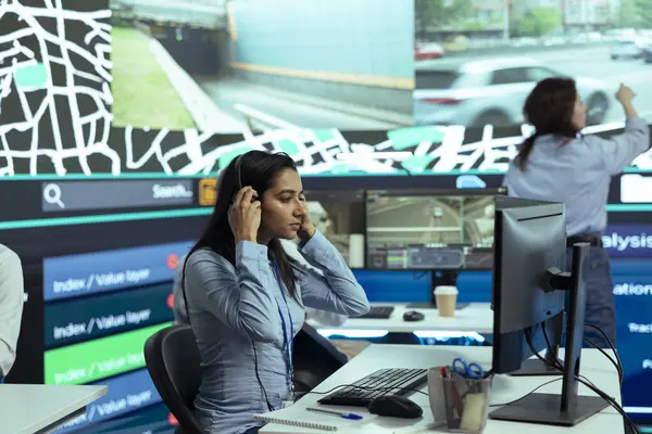 stock image Indian call center operator gives updates on order tracking activity, handling delay complains from clients. Woman monitoring delivery trucks routes through traffic, gps satellite radar.