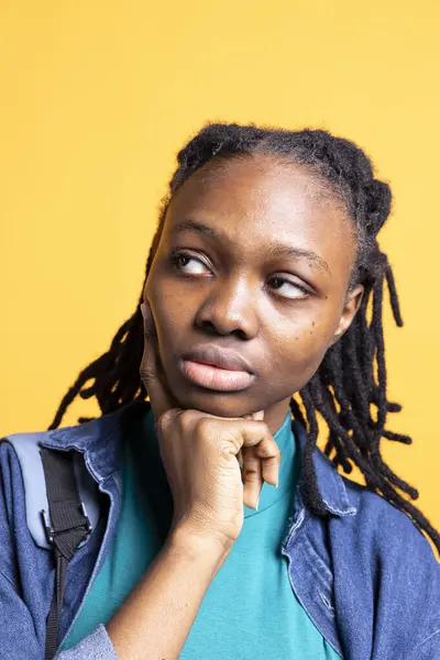 stock image African american woman thinking, being lost in thoughts, isolated over studio background, close up shot. Pensive BIPOC young girl contemplating, caught in imagination process