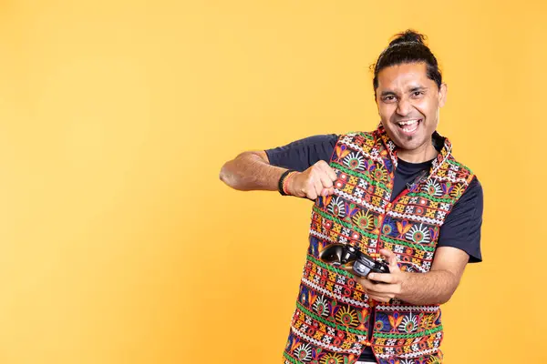 stock image Portrait of radiant indian person celebrating after winning game on gaming console. Upbeat player feeling euphoric after being victorious in videogame using joypad, studio backdrop