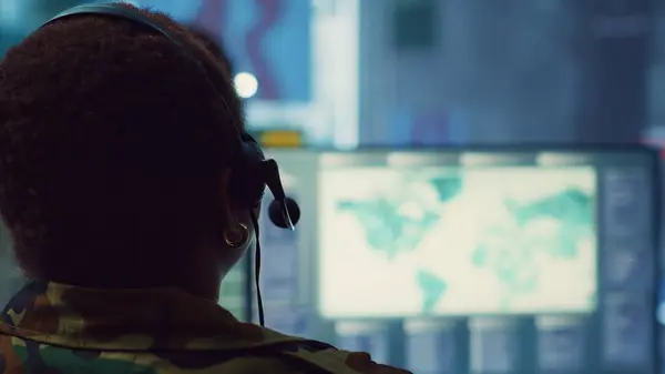 stock image Woman military personnel tracking enemy vessels on the coast line territory, working on national safety and providing real time data to the dispatch center. Reconnaissance system. Camera A.