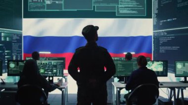 Rus askeri personeli yüksek teknoloji devlet dairesinde sahte haberler yayıyor ve melez savaş propagandası yapıyor, tehditler savuruyor. Rus ordusu askeri rakiplerinden gizli bilgileri çalıyor. Kamera B.