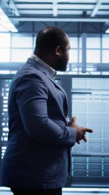 Dikey video yönetimi sunucu tarım ekipmanlarını denetliyor, süper bilgisayarlar arasında yürüyor. Bilgi işlem merkezi çalışma alanının değerlendirmesini yapan bilişim uzmanı, ekipman kontrolü, izleme performansı, kamera B