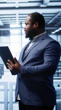 Veri merkezindeki dikey video yazılım mühendisi sorunları çözmek için tablet üzerindeki hata kontrol araçlarını çalıştırır. Bilişim uzmanı, dijital aygıt kullanılarak platformların performansını etkileyen ağ sorunları arıyor