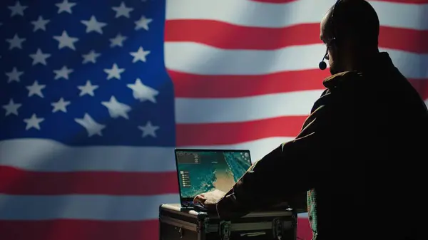 stock image US Air Force agent using radar system on laptop to detect incoming ballistic missiles. American NATO army soldier scanning rockets approaching borders, deploying shields, United States flag, camera B