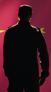 Dikey görüntülü asker, Çin bayrağına el sallayarak selam veriyor. Ülkesine hizmet etmekten gurur duyuyor. Çin Ordusu personeli milli marşı dinlerken askeri selamlama hareketi yapıyor, kamera B