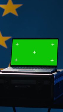 AB 'nin dikey video ittifak mühendisi sosyal medyadaki sahte hesaplardan korunmak için yeşil ekran dizüstü bilgisayar kullanıyor. Avrupa Birliği için siber güvenlik işi yapan teknisyen. Model not defteri, kamera A