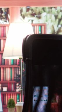 Açılış yatırımı ve genişlemesi için finansal analiz planları yürüten bir iş girişimcisinin dikey video boş modern ofisi. Bilgi grafikleri ve banka hesap analizleri üzerinde uzaktan çalışma.