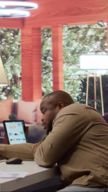 Bütçeyi gözden geçirmek için yıllık satış raporlarını hesaplarken uyuyakalan Dikey Video Girişimcisi, evden çalışmaktan yorgun ve bitkin hissediyor. Bitkin bir iş adamı. Kamera B.