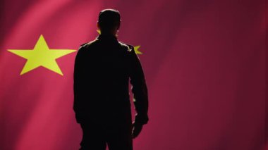 Asker, Çin bayrağına el hareketiyle selam veriyor. Ülkesine hizmet etmekten gurur duyuyor. Çin Ordusu personeli milli marşı dinlerken askeri selamlama hareketi yapıyor, kamera B