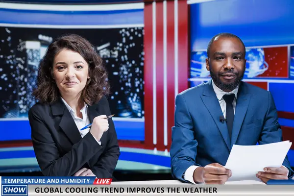 stock image Presenters talk about new weather heat, experts launching global cooling trend to improve temperature during summer. Team of diverse newscasters present modern alternatives on live broadcast.