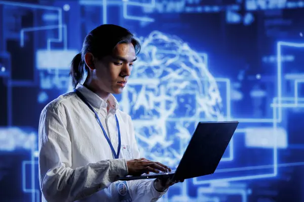 stock image Engineer in server room uses device for artificial intelligence computing simulating human brain through self learning algorithms. Cloud computing business executive works with AI deep neural networks