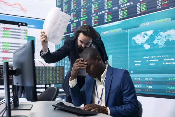 stock image Irritated angry team leader screaming at his coworker after he failed to calculate expenditures, showing his disappointment in front of everyone. Furious dissatisfied business manager.