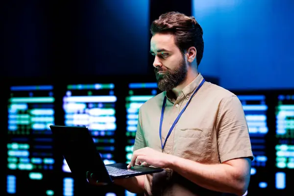 stock image Specialist using laptop to do scans on blade servers in data storage facility. Cloud computing computer service business used for complex calculations and massive datasets processing