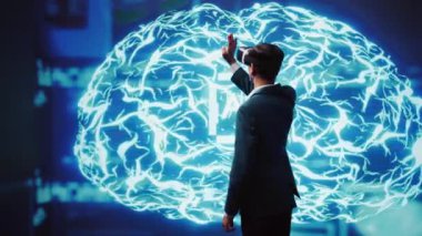VR kulaklık takan bilgisayar bilimcisi insan beyninin yapay zeka simülasyonuna bakıyor. Hintli adam, makine öğrenme algoritmalarını gösteren yapay zeka görselleştirmesi ile etkileşimde, kamera B