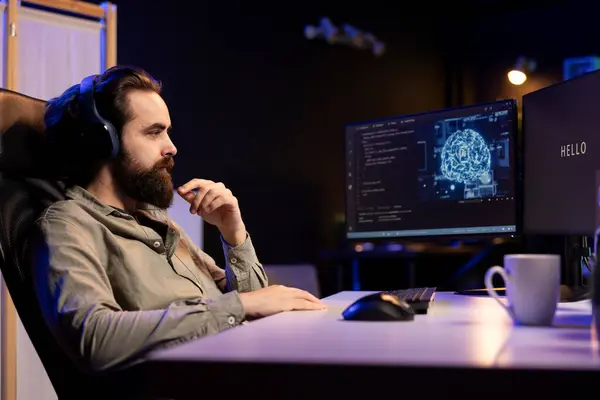 stock image Programmer getting interrupted by AI becoming sentient while listening music, saluting and asking questions about itself. Artificial intelligence becoming self aware, greeting man wearing headphones