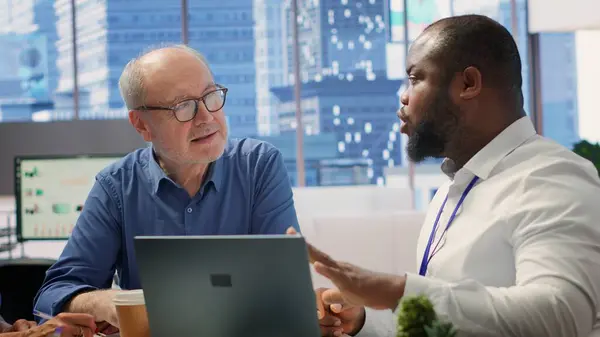 stock image Elderly couple receiving professional financial advice on retirement planning, focusing on optimizing their savings, investments and pension plans. Senior clients meeting with advisor. Camera A.