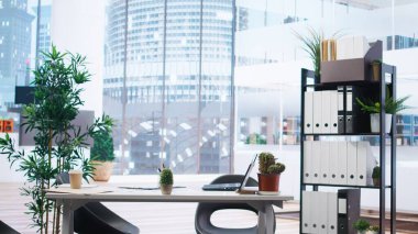 Empty financial department office used for budgeting, forecasting, and financial analysis purposes. Bright modern company workspace with nobody in and devices left open on desks clipart