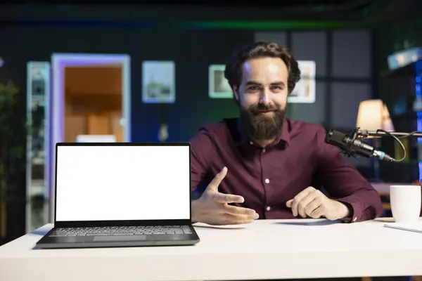 stock image Smiling influencer talking to audience about recent news headlines, reading from mockup laptop. Cheerful man discussing with subscribers, presenting information from isolated screen notebook