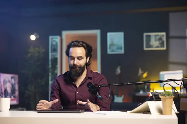 stock image Man in studio endorsing laptop from brand sponsoring video, talking in professional microphone. Content creator does influencer marketing by promoting notebook, recording with high tech mic