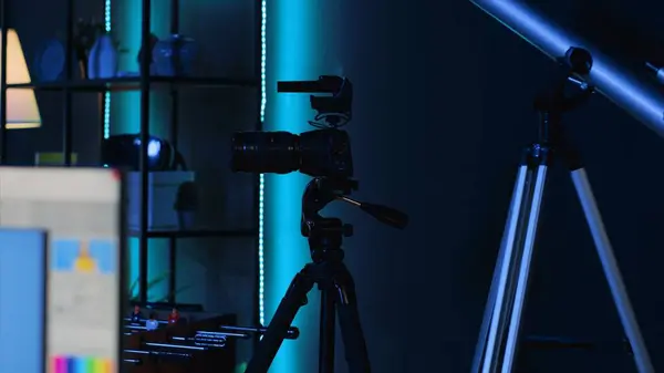stock image Professional camera equipment in empty blue neon lit creative photography studio. Video production gear in multimedia agency office specialized in post production editing