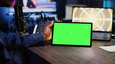 Adam internet kliplerini yeşil ekran tabletinde oturma odası stüdyosunda sunucusuyla birlikte izleyerek podcast 'e davet edildi. Konuk ve sunucu çevrimiçi komedi şovu sırasında modelleme cihazındaki videolara tepki veriyor.