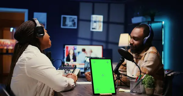 stock image Isolated screen tablet next to cohosts streaming podcast using professional vlogging gadgets on vlog channel. Chroma key device between podcasters meeting in studio to film show