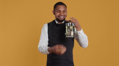 Gülümseyen dost canlısı garson, tuzluktan tuz döküyor, baharat taşıyor ve beş yıldızlı bir restoranda müşterilere servis yapıyor. Konukseverlik sektöründe yemek işçisi. Kamera B.