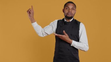 Sağda solda dost canlısı restoran çalışanları büyük müşteri hizmetleri için reklam yapıyor. Garson, yemek sektöründe profesyonellik gösteriyor. Kamera B.