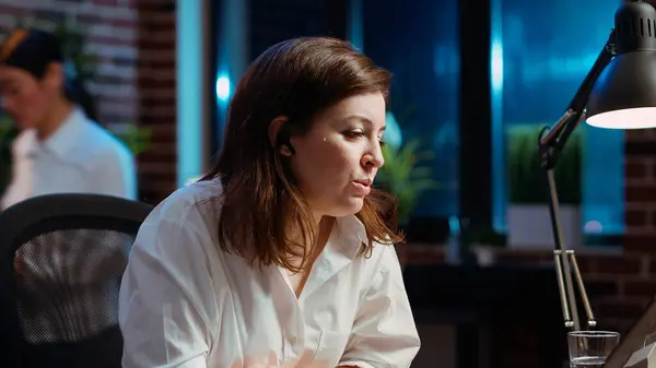 stock image Employee calls manager remotely using internet videocall to ask for feedback on project progress. Worker in brick wall office requesting assistance from team leader in teleconference meeting, camera B