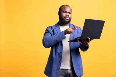 Video konferans sırasında iş arkadaşlarıyla tartışan sinirli bir adam, stüdyo geçmişi. Yönetici, çalışanların performansından rahatsız. Adresi çevrimiçi olarak görüntülü arıyor.