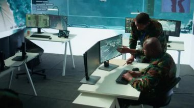 Uydu sistemleri hakkında toplanan kritik bilgileri ele alan modern bir operasyon merkezinde askeri personel, saha görevlerini destekleyen gerçek zamanlı veriler. Ulusal güvenlik için ordu protokolleri. Kamera B.