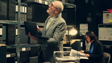 Özel dedektif arşivdeki dava isimlerine dayalı dosyaları arıyor, yasal belgeleri ve dizüstü bilgisayardaki gizli bilgileri arıyor. Kriminoloji bölümünde çalışan bir ajan. Kamera A.