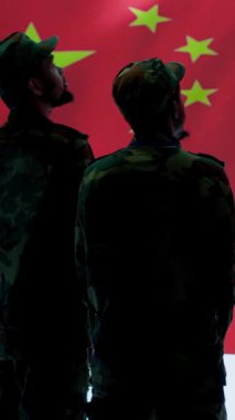 Vertical Video Cybersecurity specialist in Chinese military command post analyzes data to inflict fear of communism regime. Fake news and propaganda scaring the population, Chinese flag on big screen