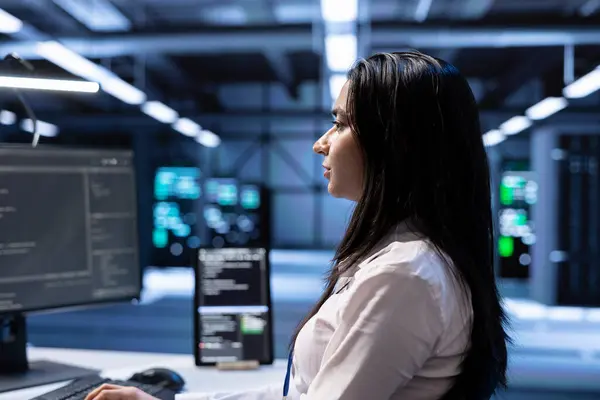 stock image Admin in server hub checking recovery plan, monitoring data center energy consumption across components, making sure sensors are functioning optimally, doing routine disk checks, close up